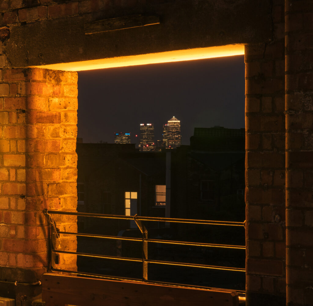 Bespoke lighting design bu Michael Grubb Studio transforms Dalston Roofpark into a dynamic event space, using warm-toned filters, integrated LEDs, and sustainable solutions to enhance the atmosphere after dark.