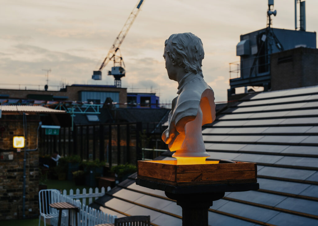 Bespoke lighting design bu Michael Grubb Studio transforms Dalston Roofpark into a dynamic event space, using warm-toned filters, integrated LEDs, and sustainable solutions to enhance the atmosphere after dark.